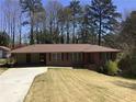 Charming one-story brick home with well-maintained lawn and covered parking at 4643 Wesley Dr, Austell, GA 30106