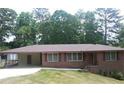 Charming one-story brick home with well-maintained lawn and covered parking at 4643 Wesley Dr, Austell, GA 30106