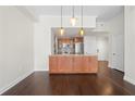 Open-concept space featuring hardwood floors, pendant lighting, and kitchen with island at 1101 Juniper Ne St # 1504, Atlanta, GA 30309