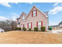 Two-story house with red shutters, a well-kept lawn, and beautiful curb appeal at 1644 Cutters Mill Dr, Lithonia, GA 30058