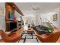 Modern living room with sleek furniture, a stylish entertainment center, and bright natural light at 2009 Kensington Green Se Dr, Smyrna, GA 30080
