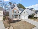 Attractive two-story home featuring stone accents, a manicured lawn, and a two-car garage at 3810 Branch Bluff Ln, Cumming, GA 30040