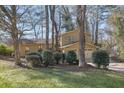 Inviting exterior view of the two-story home with mature trees and well-maintained landscaping at 4570 Nantucket Sw Dr, Lilburn, GA 30047