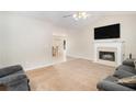 Bright living room features a cozy fireplace, plush carpeting, and ample natural light at 60 Cypress Dr, Covington, GA 30016