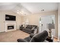 Cozy living room with a fireplace, ceiling fan, and comfortable seating at 60 Cypress Dr, Covington, GA 30016
