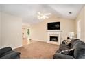 Bright living room with fireplace, vaulted ceiling, and adjacent dining area at 60 Cypress Dr, Covington, GA 30016