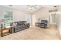 Cozy living room featuring neutral walls, comfortable seating, and natural light from a front-facing window at 60 Cypress Dr, Covington, GA 30016