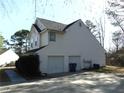 View of the home's attached two-car garage and driveway at 1662 Maple Trace Ct, Grayson, GA 30017