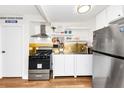 Cozy kitchen showcasing stainless steel appliances and modern lighting at 2285 Peachtree Rd Ne # 803, Atlanta, GA 30309