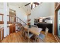 Open dining area features hardwood floors, cathedral ceilings, and an adjacent kitchen and stairway at 2664 Stonebrook Ne Ct, Roswell, GA 30075