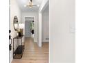 Bright entryway featuring wood floors, modern lighting fixture, and stylish console table at 6710 Hidden Brook Trl, Atlanta, GA 30349