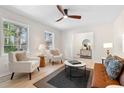 Bright and airy living room with stylish furniture, modern rug, and hardwood flooring at 6710 Hidden Brook Trl, Atlanta, GA 30349