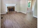 Open-concept living room with stone fireplace and wood floors at 195 Baggett Cir, Dallas, GA 30157