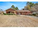 Lovely ranch-style home showcasing a welcoming front porch and mature trees at 2297 Hylaea Rd, Tucker, GA 30084