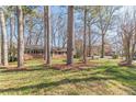 Traditional ranch-style home featuring a well-maintained lawn, classic brick facade, and mature trees at 407 North Ave, Atlanta, GA 30354