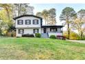 Attractive two-story home with white siding, black trim, a covered porch, and a well-manicured front yard at 4087 Signal Rdg, Lilburn, GA 30047