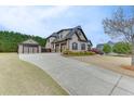 Charming suburban home with three-car garage, spacious driveway, and meticulously maintained landscaping at 1698 Little Fox Ln, Dacula, GA 30019