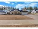 Attractive single-story home with a two-car garage, front porch, and a spacious front yard in a neighborhood at 598 Barnwood Dr, Rockmart, GA 30153