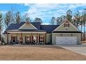 Inviting single-story home featuring a covered front porch, two-car garage, and a well-maintained lawn at 598 Barnwood Dr, Rockmart, GA 30153