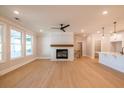 Sunlit living room features hardwood floors, a cozy fireplace, and seamless flow to kitchen at 108 Redford Ln, Canton, GA 30115