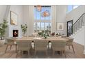 Open-concept dining room with large windows, modern lighting, and ample seating at 1171 Lupo Loop, Chattahoochee Hills, GA 30268