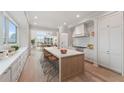 Spacious kitchen features a large island, stainless steel appliances, and white cabinetry at 1171 Lupo Loop, Chattahoochee Hills, GA 30268
