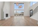 Spacious living room featuring high ceilings, large windows, and a modern fireplace at 1171 Lupo Loop, Chattahoochee Hills, GA 30268