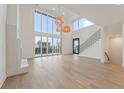 Bright, open living space with soaring ceilings, a fireplace, and expansive glass doors at 1171 Lupo Loop, Chattahoochee Hills, GA 30268