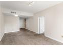 Spacious living room with neutral walls, carpeted floors, and entryways to other parts of the house at 195 14Th Ne St # 1404, Atlanta, GA 30309