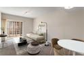 Well-lit living room featuring carpet, neutral walls, comfortable seating, and an access to balcony at 195 14Th Ne St # 1404, Atlanta, GA 30309