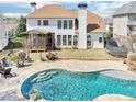 Backyard with a beautiful pool, patio, screened in porch, and plenty of space for entertaining at 3530 Horizon Ct, Cumming, GA 30041