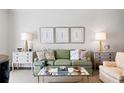 Bright living room featuring a comfortable green sofa, stylish decor, and elegant side tables at 39 Paces West Nw Dr, Atlanta, GA 30327