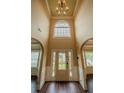 Grand foyer with high ceilings, a decorative front door, and beautiful hardwood floors and trim at 85 Providence Pkwy, Covington, GA 30014