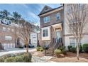 Attractive brick townhouse with inviting stairs leading to the front door at 145 Laurel Crest Aly, Johns Creek, GA 30024