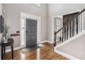 Inviting foyer with hardwood floors, a gray front door, staircase, and elegant decor at 358 Woodbrook Crst, Canton, GA 30114