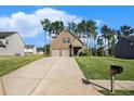 Inviting two-story home featuring a well-maintained lawn, a double garage, and a classic mailbox at 71 Pulaski Ave, Hampton, GA 30228