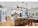 Bright, open kitchen featuring an island with seating, modern appliances, and hardwood floors at 11 York Trce, Cartersville, GA 30121