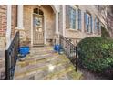 Charming front entrance with stone steps, wrought iron railings and decorative potted plants at 2362 Saint Davids Nw Sq # 4, Kennesaw, GA 30152