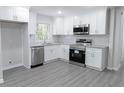 Bright kitchen features stainless steel appliances, granite countertops, and updated cabinets at 3893 Bonnie Se Ln, Atlanta, GA 30354