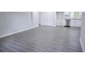Spacious living area featuring new gray flooring, fresh paint and base trim, and ample natural light at 3893 Bonnie Se Ln, Atlanta, GA 30354