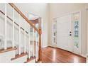Inviting foyer with hardwood floors, stairs and a view into other rooms at 2118 Township Dr, Woodstock, GA 30189