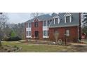 Traditional brick home featuring white trim, bay windows, dormers and a well-manicured lawn at 3715 Millers Pond Way, Snellville, GA 30039