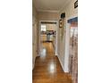 Hallway view with hardwood floors leading to the kitchen, accented by decorative doorway beads at 3715 Millers Pond Way, Snellville, GA 30039
