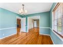 Well-lit dining room featuring hardwood floors, chair rail, and a modern chandelier at 3844 Rena Se Ln, Smyrna, GA 30082