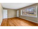 Sun-filled living room with hardwood flooring, freshly painted walls, and a large window at 3844 Rena Se Ln, Smyrna, GA 30082