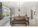 Bright dining area featuring modern decor, light floors, a large table, and a view to the kitchen at 515 Quinn Dr, Woodstock, GA 30188