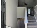 Inviting entryway featuring carpeted stairs, high ceilings, and a view into the living room at 831 Stonebrook Dr, Lithonia, GA 30058