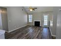Cozy living room featuring wood floors, a fireplace, and a door that leads to the back yard at 831 Stonebrook Dr, Lithonia, GA 30058