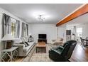Cozy living room with a plush sofa, a modern ceiling fan, and hardwood floors at 1083 Amelia Sw Dr, Marietta, GA 30060