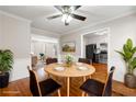 Inviting dining room showcasing hardwood floors, a round table with seating for four, and views into the kitchen and living spaces at 2300 Newport Lndg, Alpharetta, GA 30009